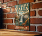 a vintage-style sign for Fall Creek Falls State Park in Tennessee, mounted on a brick wall.