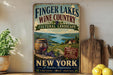 A vintage-style sign advertising Finger Lakes Wine Country, New York, featuring a scenic landscape with a barrel of wine, grapes, and a wooden paddle.