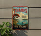 a vintage-style metal sign advertising a trip to the Coromandel Peninsula in New Zealand.