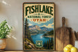 A vintage-style sign for Fish Lake National Forest in Utah, featuring a scenic landscape with mountains, a lake, and pine trees.