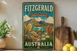 a vintage-style sign for Fitzgerald Biosphere Reserve, Australia, with a scenic landscape of mountains, flowers, and a body of water.