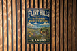 A vintage-style metal sign for the Flint Hills National Wildlife Refuge in Kansas, featuring a bird and a field with flowers.