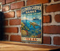 A vintage-style metal sign for the Flower Garden Banks National Marine Sanctuary in Texas, featuring an illustration of a turtle swimming among coral and fish.