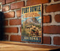 A vintage-style metal sign for Fort Bowie National Historic Site in Arizona, featuring a desert landscape with a building and a cannon.