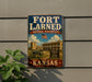 A vintage-style sign for the Fort Laredo National Historic Site in Kansas, featuring an American flag and a building with a cannon.