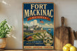 A vintage-style metal sign for Fort Mackinac, Michigan, featuring an illustration of the fort and surrounding landscape.