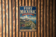 A vintage metal sign for Fort Mackinac, Michigan, featuring a scenic illustration of the fort and surrounding landscape.