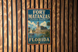 A vintage-style sign for Fort Matanzas National Monument in Florida, featuring a castle and palm trees, is displayed on a wooden wall.