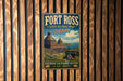 A vintage metal sign for Fort Ross State Historic Park in California, featuring a barn and a cannon, is displayed on a wooden wall.