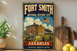 A vintage-style metal sign for Fort Smith, Arkansas, featuring an illustration of a historic building with an American flag in the background.