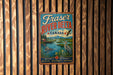 A vintage-style metal sign for Fraser River Delta, Canada, featuring a scenic illustration of the river, mountains, and wildlife.