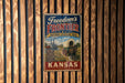 A vintage metal sign for the Freedom's Frontier National Heritage Area in Kansas, featuring an illustration of a wagon and a horse.
