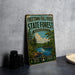 A vintage metal sign for the Freetown-Fall River State Forest in Massachusetts, featuring a scenic image of a forest and a river.