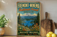 a vintage-style sign for the Fremont-WineEMA National Forest in Oregon, with a scenic mountain landscape and a lake in the background.