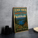 a vintage metal sign for the Fremont-Winebra National Forest in Oregon, with a mountain landscape and a lake in the background.