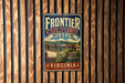 A vintage metal sign for the Frontier Culture Museum in Virginia, featuring an illustration of a wagon and a rural landscape.