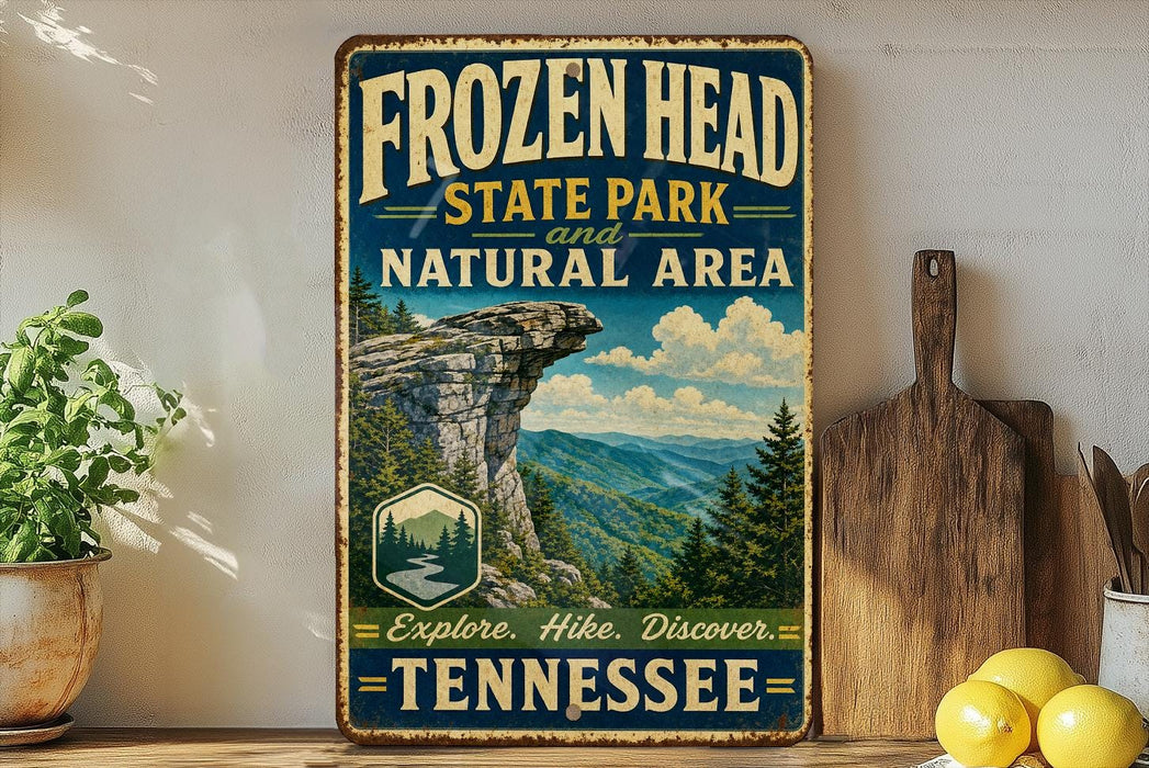 A vintage-style sign for Frozen Head State Park and the Natural Area in Tennessee, featuring a scenic mountain landscape with pine trees and a waterfall.