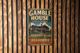 A vintage-style metal sign for the Gamble House, a historic landmark in Pasadena, California.