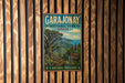 A vintage-style metal sign for the Garajonay National Park in Spain, featuring a scenic landscape with mountains, trees, and a winding path.