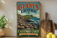 A vintage-style sign for Giant's Causeway, a famous natural landmark in Ireland, featuring a scenic image of the rugged coastline and the iconic Giant's Causeway rock formation.