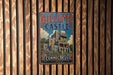 A vintage metal sign for Gillette Castle in Connecticut, featuring an illustration of the castle and the words "GILLETTE CASTLE CONNECTICUT".