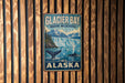 A vintage metal sign for Glacier Bay Marine Wilderness in Alaska, featuring a scenic illustration of a waterfall and mountains.