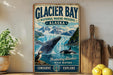 A vintage-style metal sign for Glacier Bay National Marine Preserve in Alaska, featuring an illustration of a whale and a puffin, with the text "Glacier Bay National Marine Preserve Alaska" and "Protecting Alaska's Wild Waters Conserve Explore".
