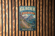 A vintage-style metal sign for Glacier National Park's Highline Trail, mounted on a wooden wall.