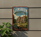 A vintage-style metal sign for Glensheen Historic Estate in Minnesota, featuring an illustration of a historic building surrounded by a garden.