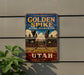 A vintage-style sign for Golden Spike National Historical Park in Utah, featuring an illustration of a steam locomotive and the text "Golden Spike" and "National Historical Park".