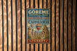 A vintage-style metal sign for the Görme National Park and the Rock Sites of Cappadocia, Turkey, featuring a hot air balloon and a castle-like structure.