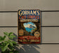 A vintage-style metal sign for Gorham's Cave Complex in United Kingdom, featuring a scenic image of the cave and a path leading through it.