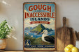 A vintage-style sign advertising the "Gough and Inaccessible Islands" in the United Kingdom, featuring a scenic illustration of the islands and a bird.