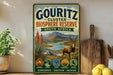 A vintage-style metal sign advertising the Gouritz Cluster Biosphere Reserve in South Africa, featuring a scenic landscape with mountains, a river, and a gazelle.