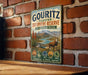 A vintage metal sign for the Gouritz Cluster Biosphere Reserve in South Africa, featuring an illustration of a mountain landscape with a gazelle.