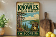 A vintage-style sign for Governor Knowles State Forest in Wisconsin, featuring a scenic landscape with pine trees, a lake, and mountains.