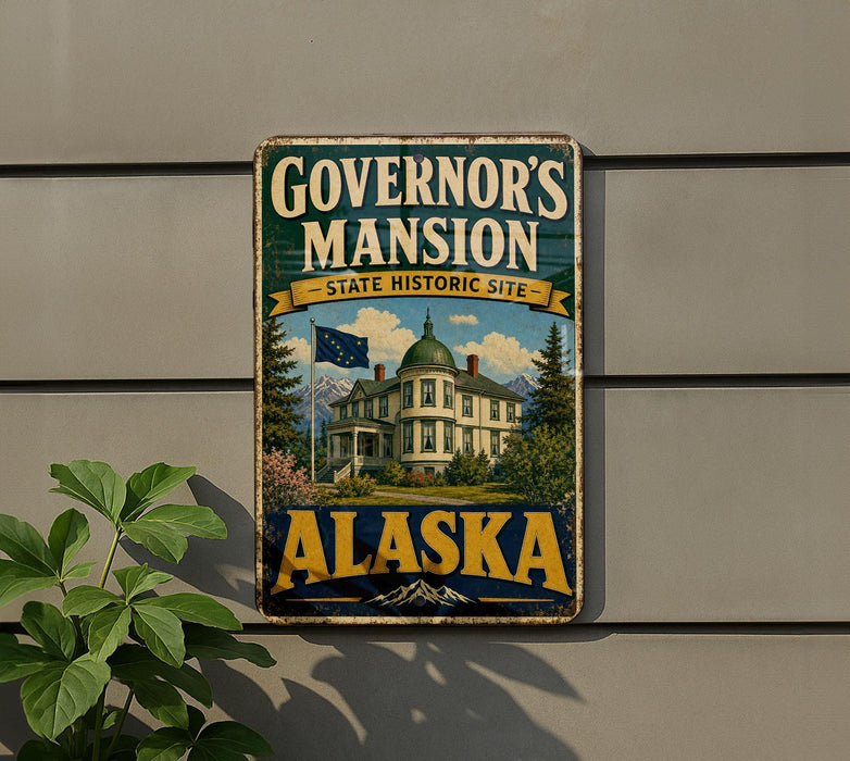 A vintage-style metal sign for Governor's mansion in Alaska, featuring a large image of the mansion and the state's flag.