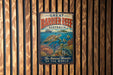 A vintage-style metal sign with the text "GREAT BARRIER REEF AUSTRALIA" and an illustration of a sea turtle swimming among colorful coral and fish.