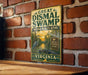 A vintage-style metal sign for the Great Dismal Swamp National Wildlife Refuge in Virginia, featuring an illustration of a bird and a swamp environment.