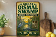 A vintage-style metal sign for the Great Dismal Swamp National Wildlife Refuge in Virginia, featuring an illustration of a heron and a swampy landscape.