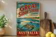 A vintage-style sign advertising the Great Sandy Strait in Australia, featuring a scenic illustration of a boat and a turtle in the water.