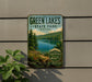 A vintage-style sign for Green Lakes State Park in New York, featuring a scenic image of the lake surrounded by trees and mountains.