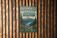 A vintage-style metal sign for Green Mountain- Tahya State Forest in Washington, featuring a scenic mountain landscape and the text "Wild Beauty Hike - Explore - Discover Every trail leads to adventure".