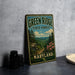 A vintage-style metal sign for the Green Ridge State Forest in Maryland, featuring a scenic landscape with pine trees, mountains, and pink flowers.