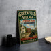 A vintage-style metal sign for "Greenfield Village" featuring an illustration of a small town with a Henry Ford-branded car, set against a backdrop of a church and other buildings.