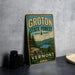 A vintage-style metal sign for Groton State Forest, featuring a scenic landscape with pine trees, mountains, and a lake.