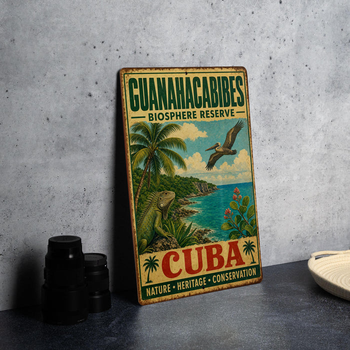 A vintage-style sign for the Guianacabibles Biosphere Reserve in Cuba, featuring a tropical landscape with palm trees, a bird, and a body of water.