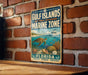 A vintage metal sign for the Gulf Islands National Seashore Marine Zone, featuring an illustration of a turtle, coral, and other marine life, mounted on a brick wall.