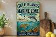 A vintage-style metal sign with a marine theme, featuring a lighthouse, turtle, dolphin, and coral, is displayed on a shelf next to a wooden cutting board and a potted plant.