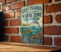 A vintage metal sign on a brick wall, depicting a marine scene with a dolphin, turtle, and coral, along with the text "Gulf Islands National Seashore Marine Zone Mississippi" and "Protect Our Waters Preserve Our Heritage".